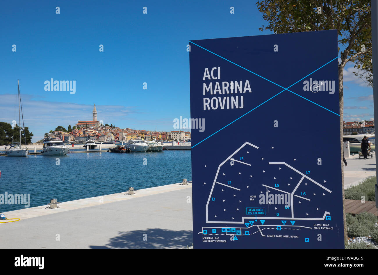 South end seaside promenade and yachts in the five star ACI marina with town of Rovinj in the background, Istria, Croatia Stock Photo