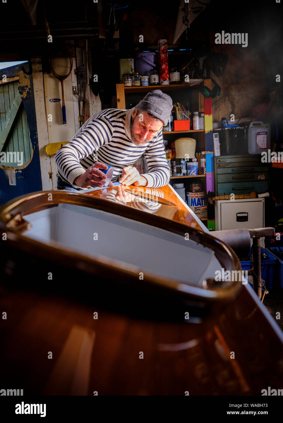 Kayak maker Chris Tipper at his workshop in Newhaven, East Sussex, UK Stock Photo