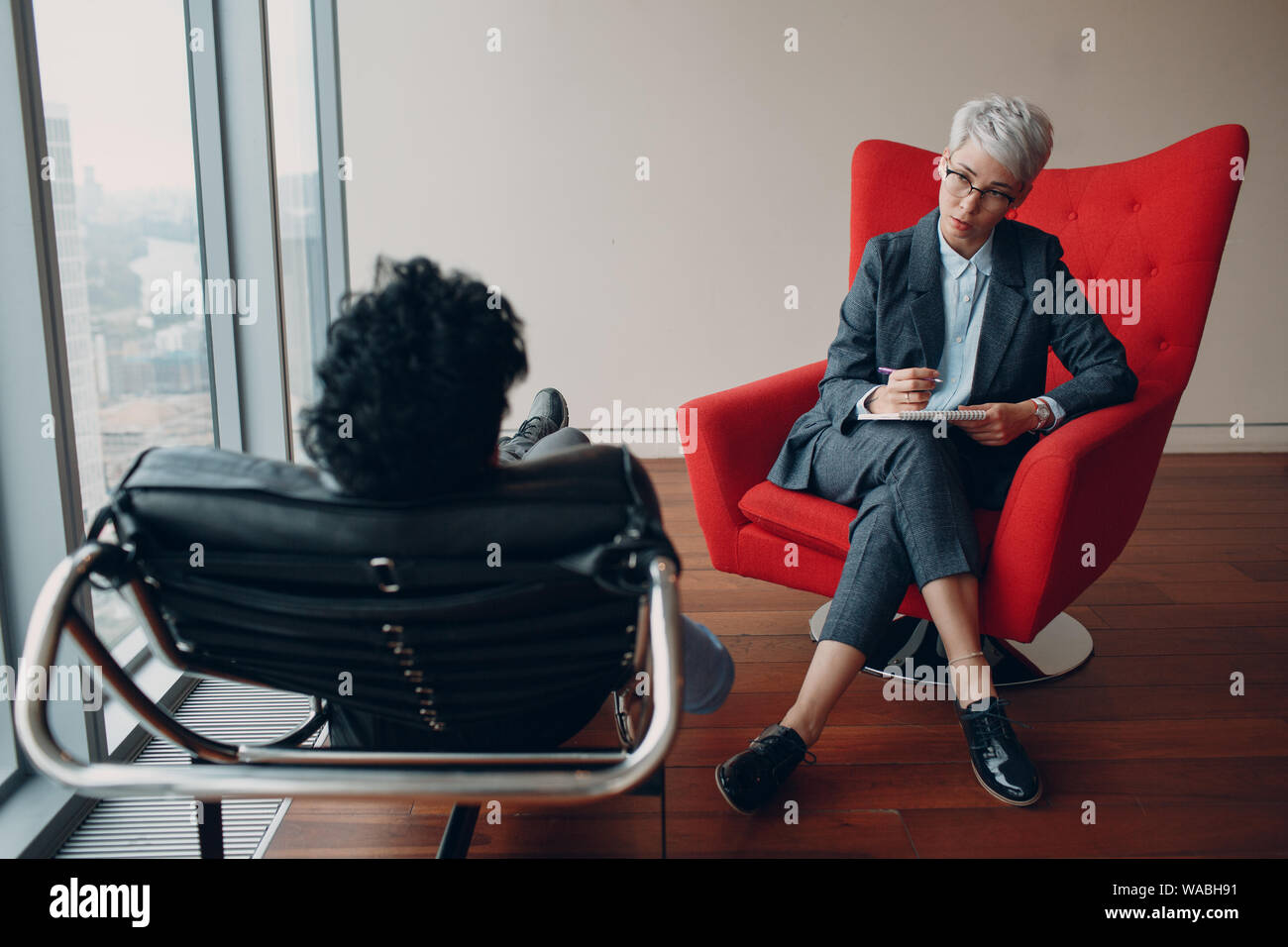 Consultation of young man patient on reception for psychologist. Stock Photo