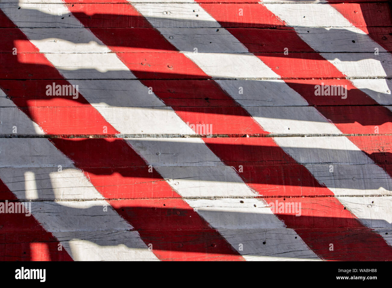 Red-white stripes on planks of footbridge. A wooden floor on the outdoor veranda. Stock Photo