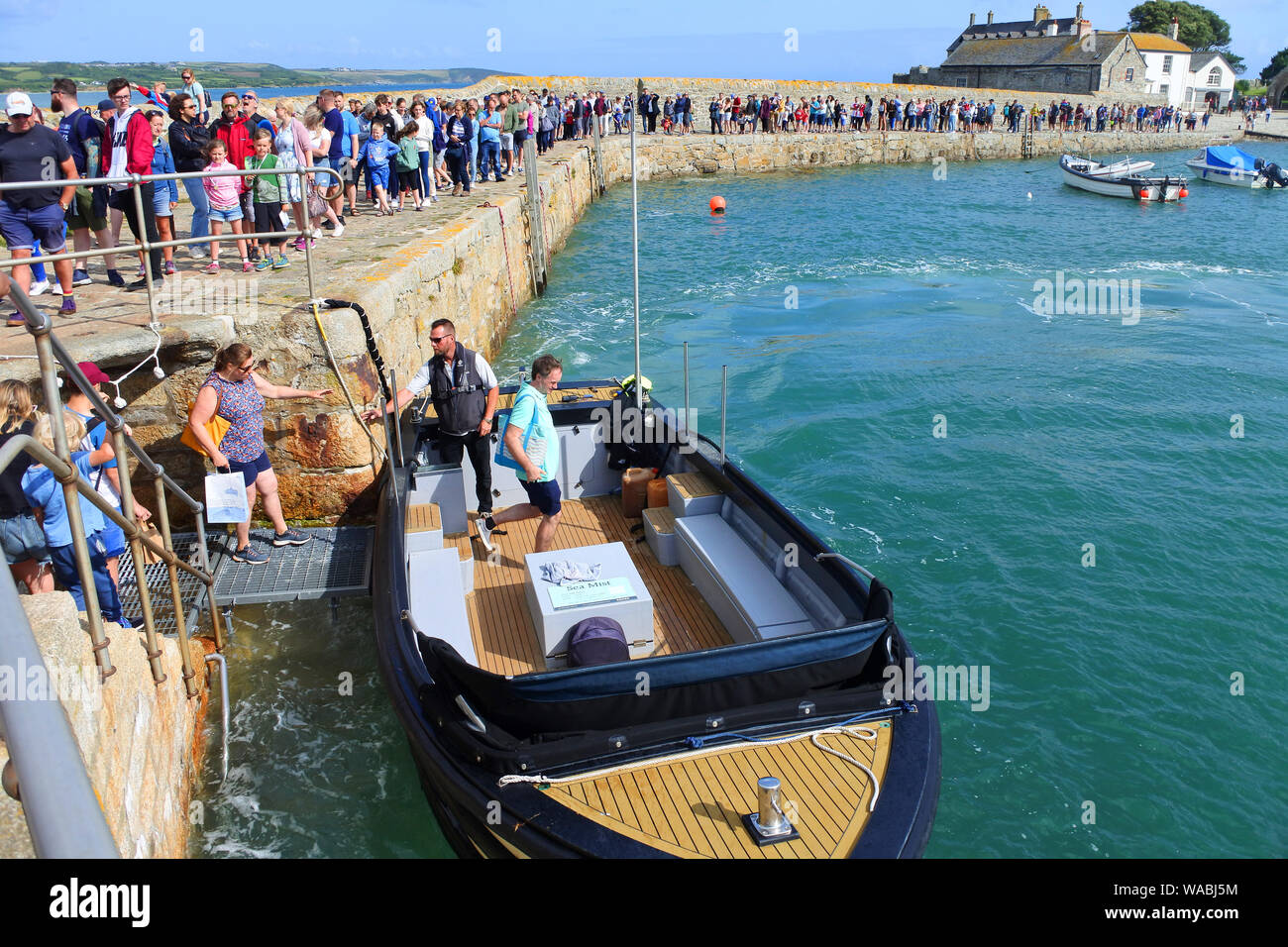 100s of tourist waiting for a ferry at St. Michael's Mount, an iconic
