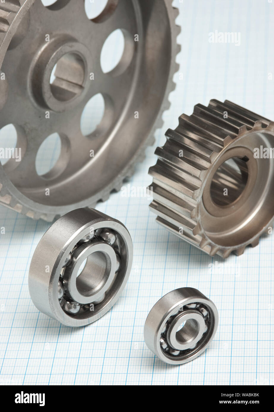 gears and bearings on graph paper Stock Photo Alamy