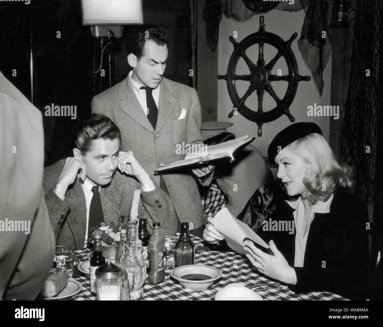 Glenn Ford and Claire Trevor as they rehearse dialogue with Michael Gordon for the film, 'The Adventures of Martin Eden' (1941) Columbia Pictures  File Reference # 33848-508THA Stock Photo