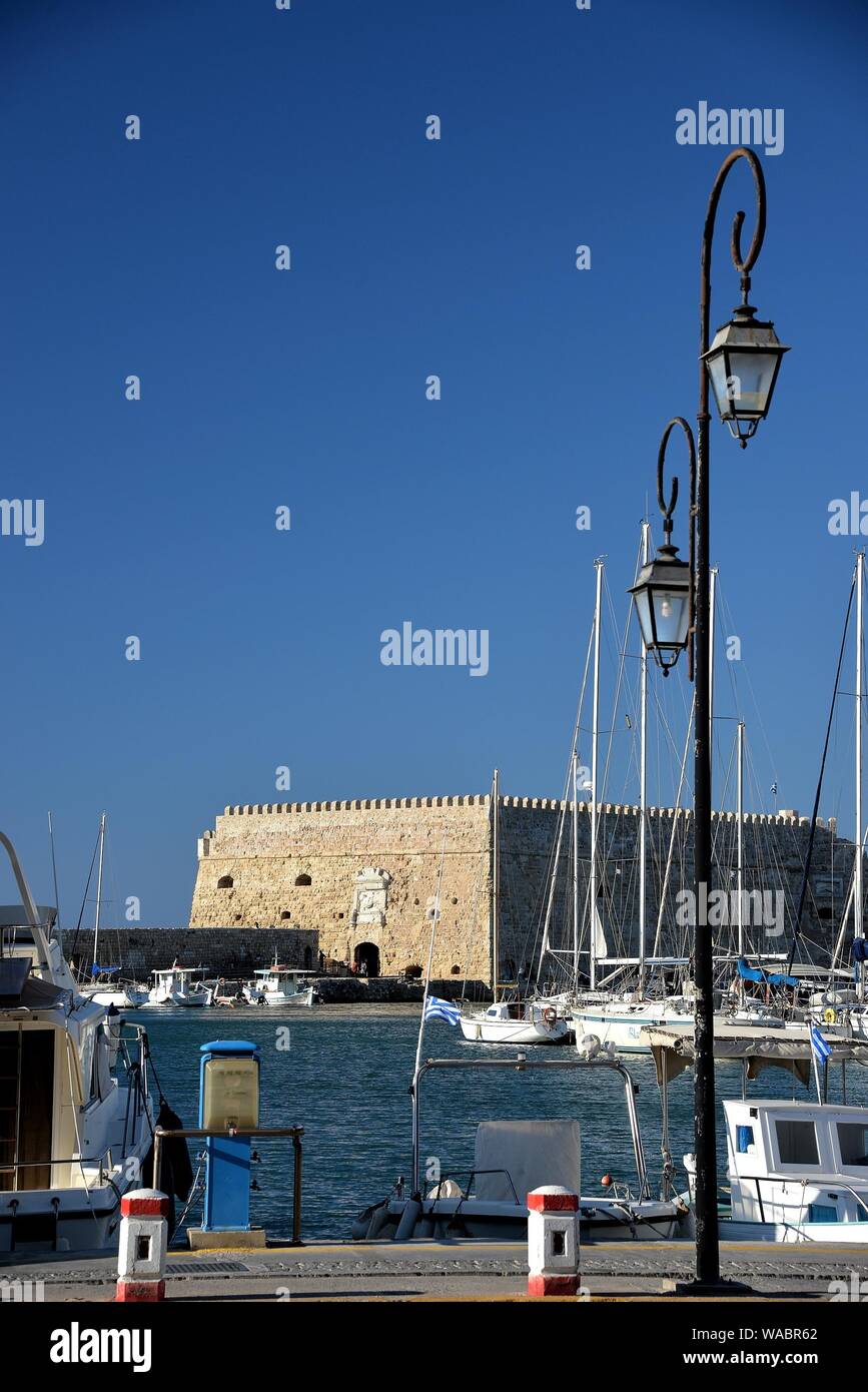 Partial view of the old port of Heraklion, Crete with the castle of Koules visible in the background. Stock Photo