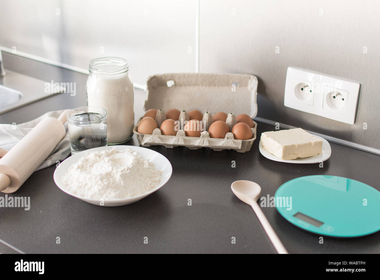 Food ingredients for baking flour, eggs, milk, sugar. Process of