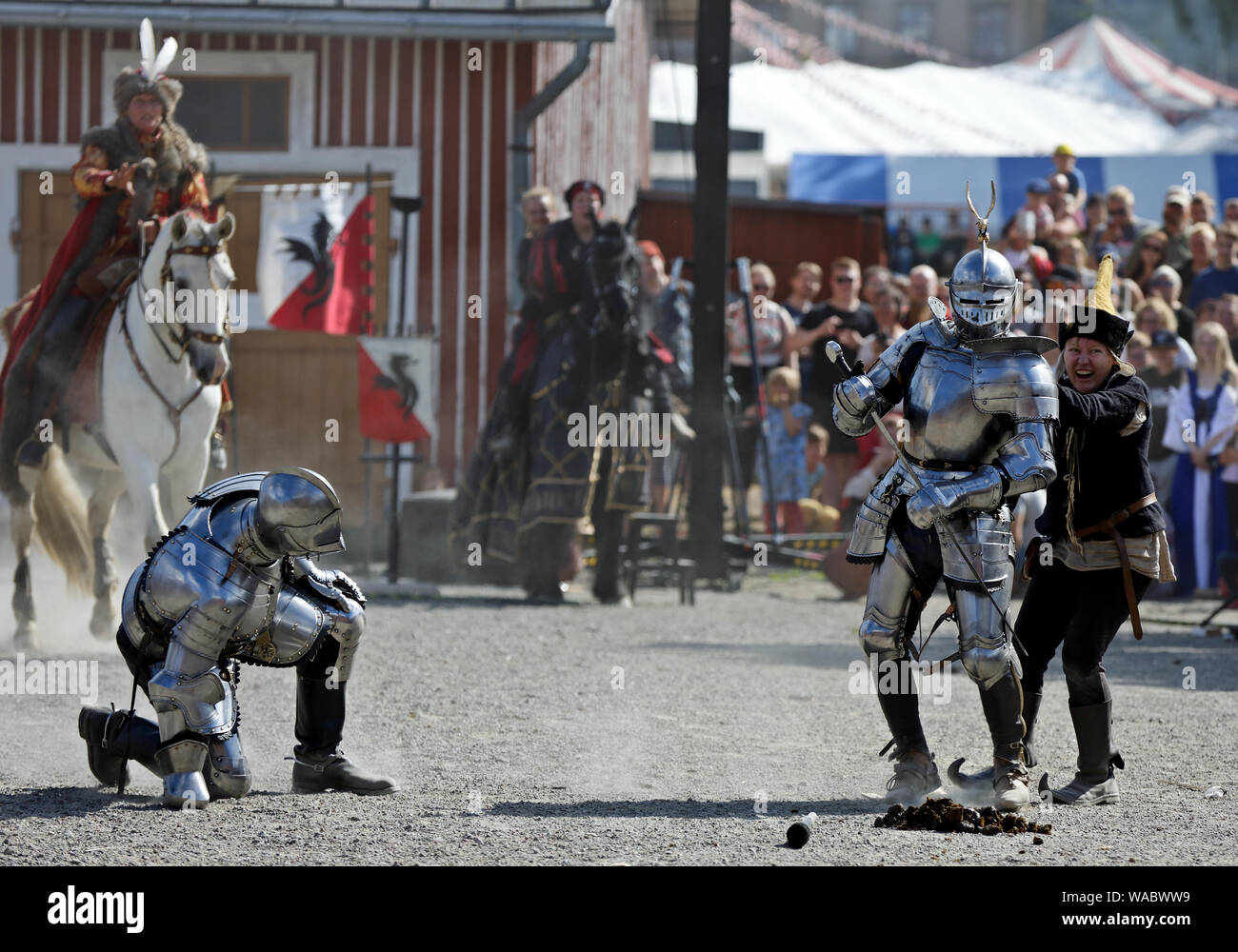 Hameenlinna Finland 08/17/2019 Medieval festival with craftsman, knights and entertainers. Two knights in harness fighting on a dusty field. Stock Photo