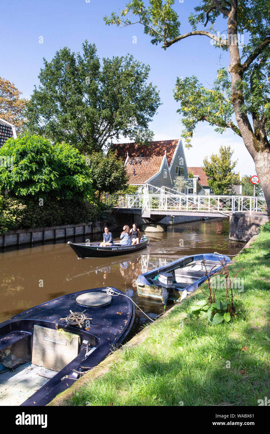 BROEK IN WATERLAND, NETHERLANDS - SEPTEMBER 1, 2018: Scenic view Broek in Waterline in North Holland with architecture and people rowing on the canal. Stock Photo