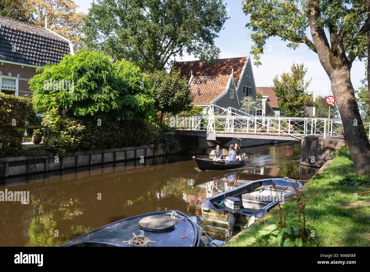 BROEK IN WATERLAND, NETHERLANDS - SEPTEMBER 1, 2018: Scenic view Broek in Waterline in North Holland with architecture and people rowing on the canal. Stock Photo