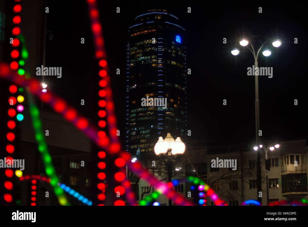 Yekaterinburg, Russia - January 17, 2019: colorful lights - a fragment of New Year's illumination outdoors in the night city and Vysotsky skyscraper o Stock Photo