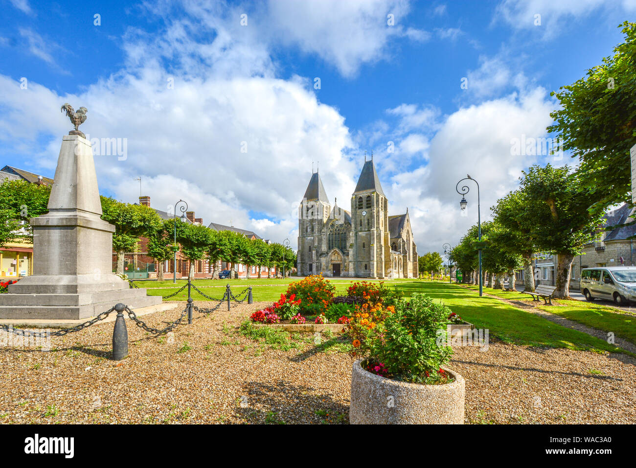 Collégiale Notre-Dame d'Écouis, a medieval catholic church with a statue of a rooster in front in the French city of Ecouis in Normandy France. Stock Photo