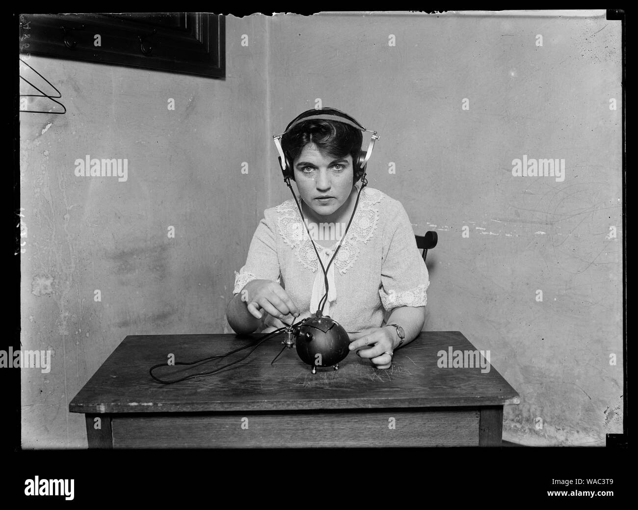 Radio nut. This term is certainly applicable to this receiving set for everything necessary for receiving music and speech by radio has been put into a coconut shell. It was built by H. Zamora, a native of Manila, Philippine Islands Stock Photo