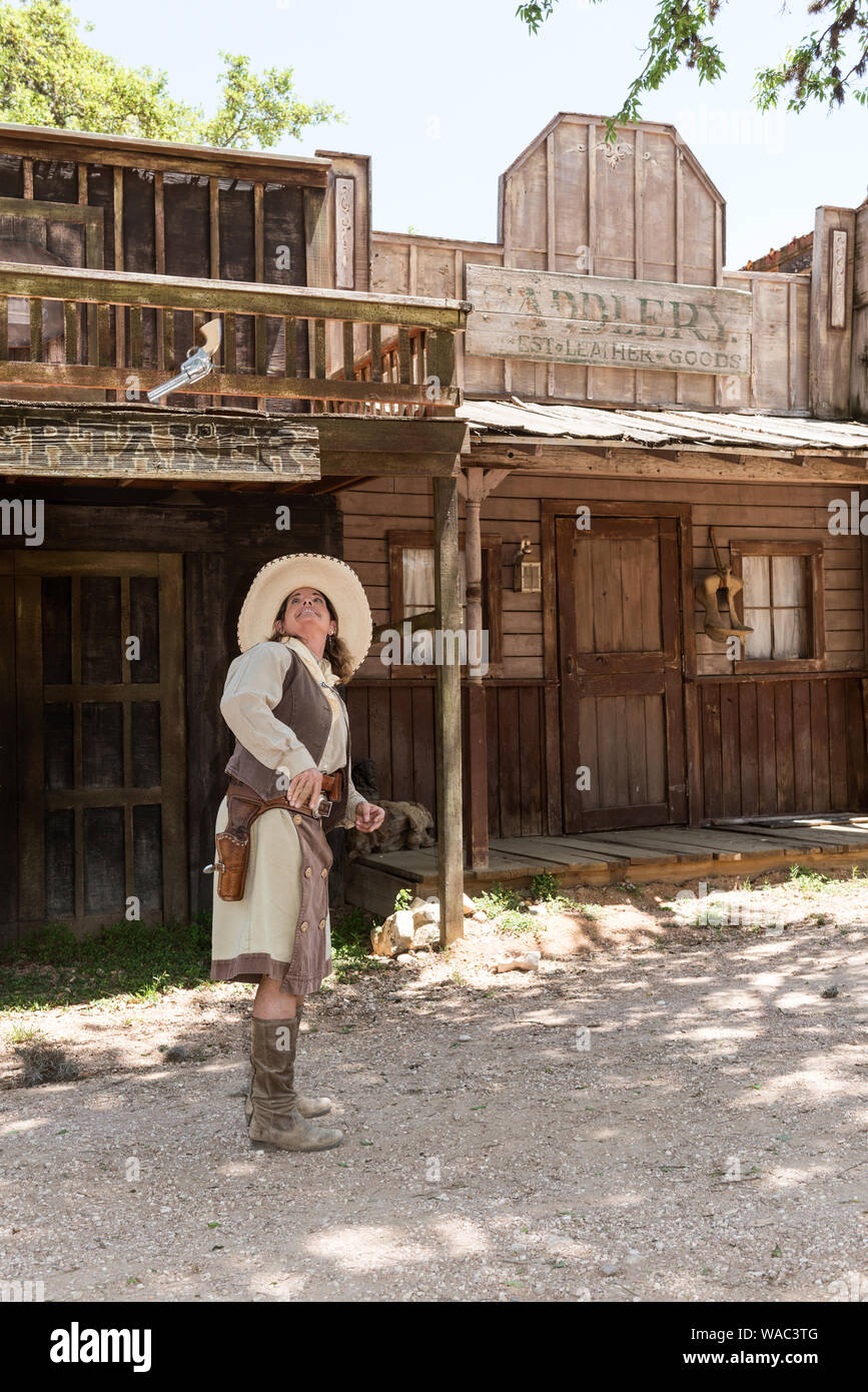 Paula Saletnik shows off her Annie Oakley-style gun-twirling and -tossing skills at the Old West town, audience-participation theme park, working cattle ranch, frequent movie, TV-commercial, and country-music video set at