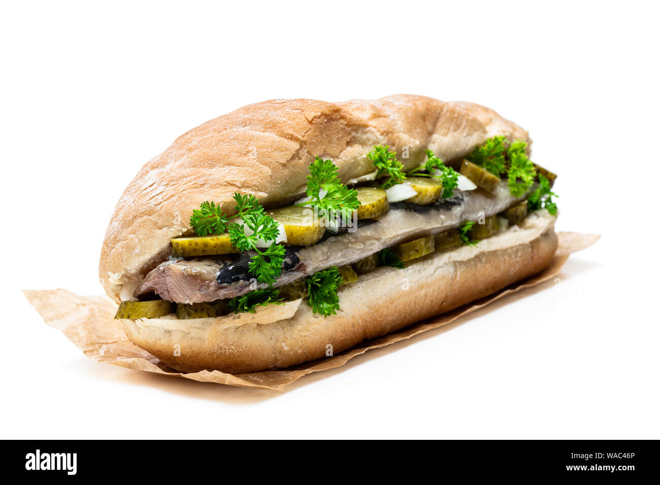Traditional Dutch sandwich with herring and pickles isolated on white