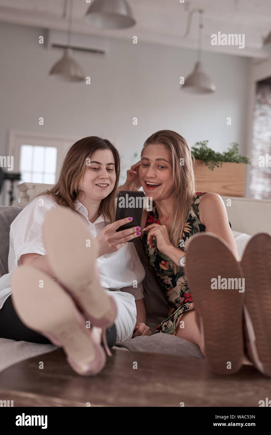 girls on couch Stock Photo Alamy