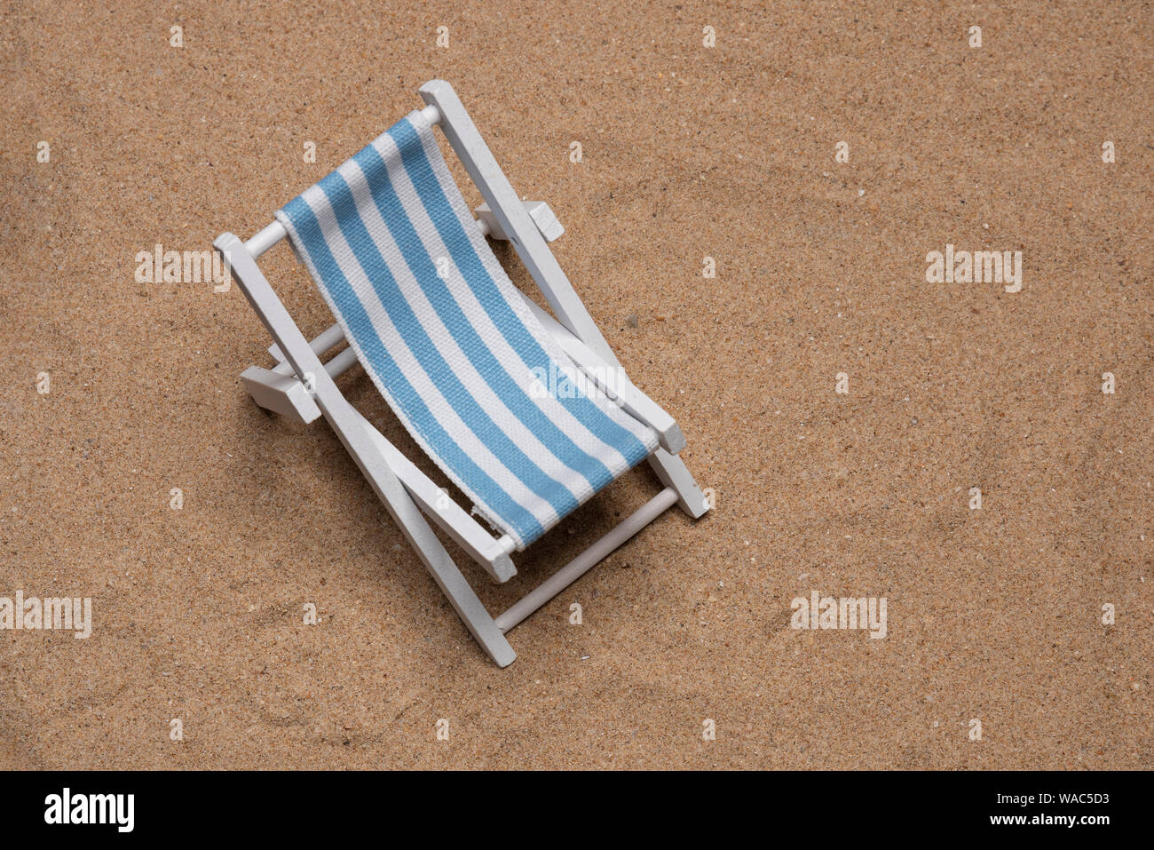Sunbed laying on very fine sand in portrait flat lay with copy space in landscape mode Stock Photo