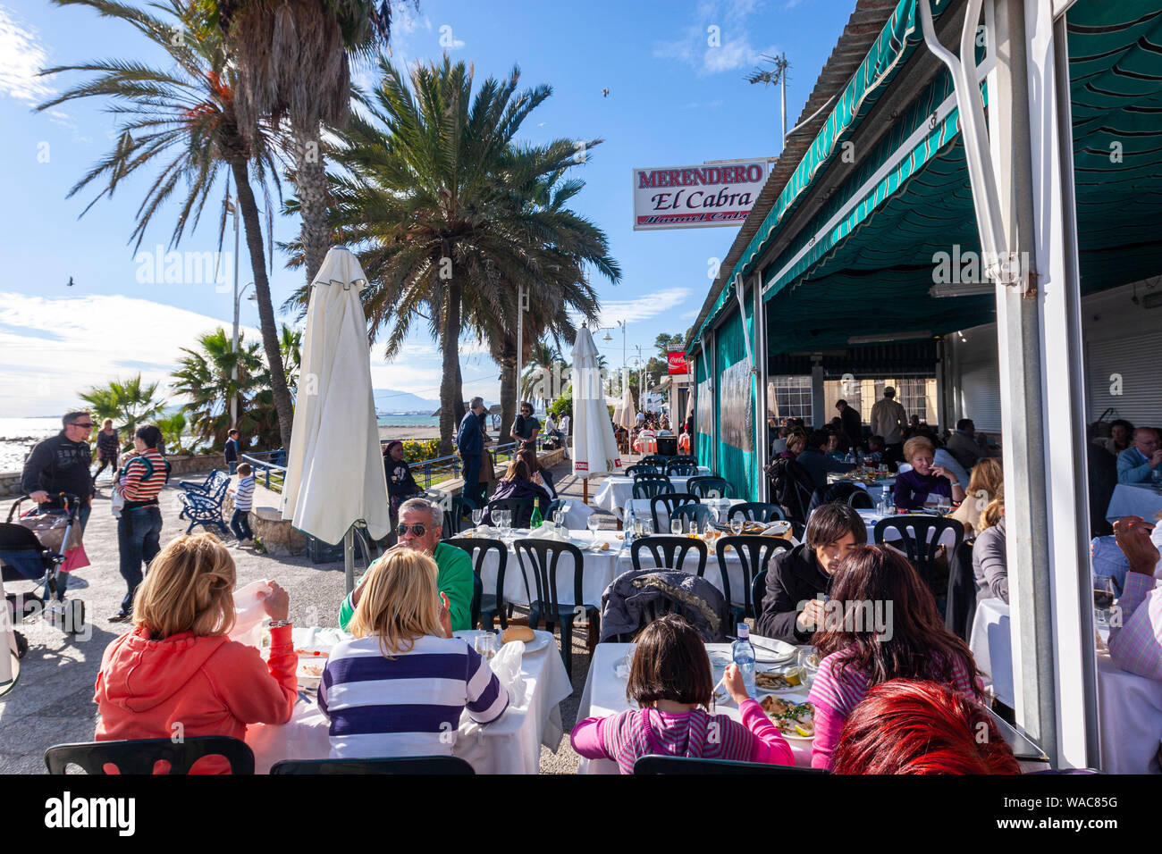 Eating in the terrace of Restaurante El Cabra , Pedregalejo, Malaga, Andalucia, Spain Stock Photo
