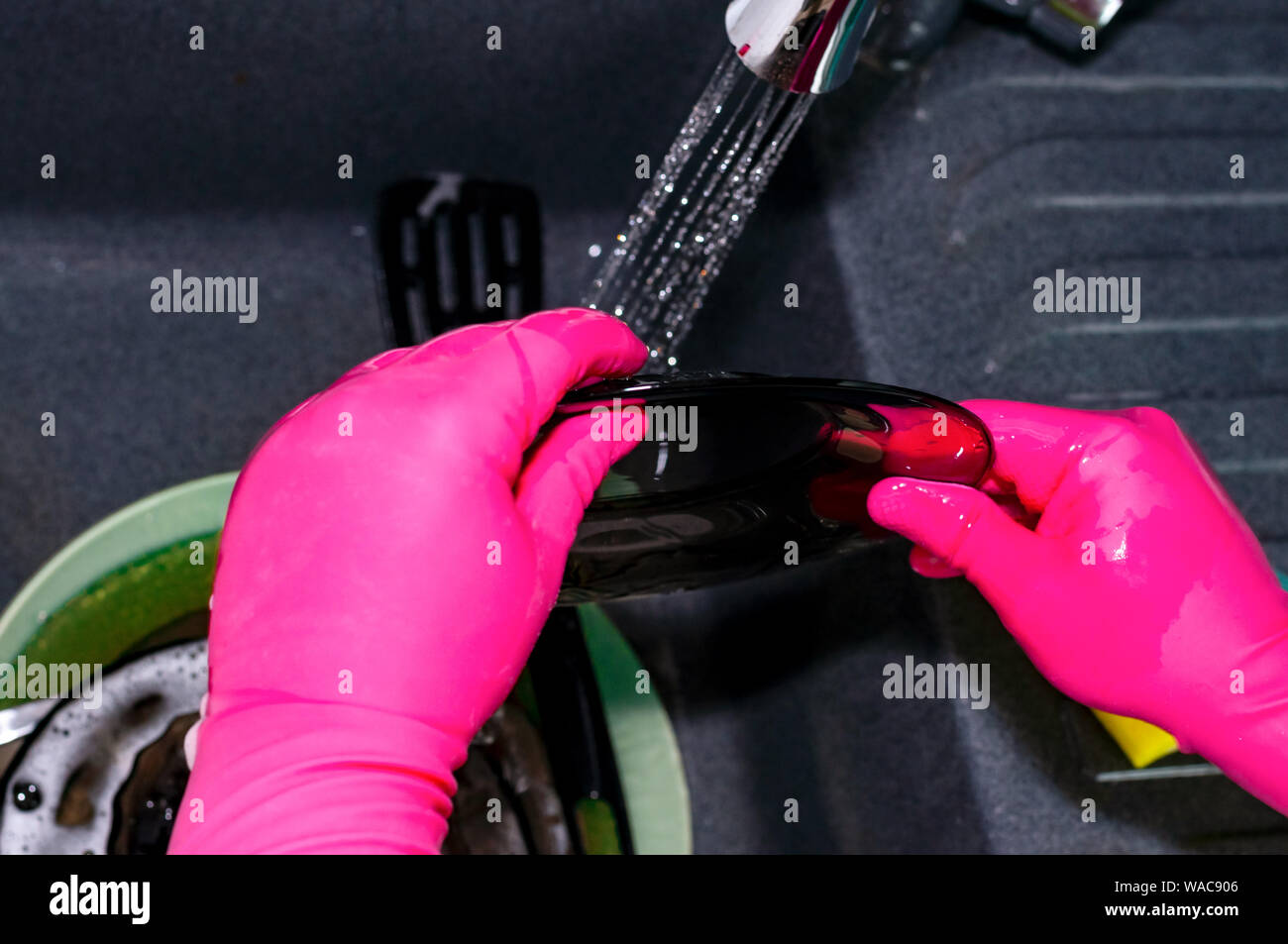 The process of washing plates in the sink, hands and plates closeup ...