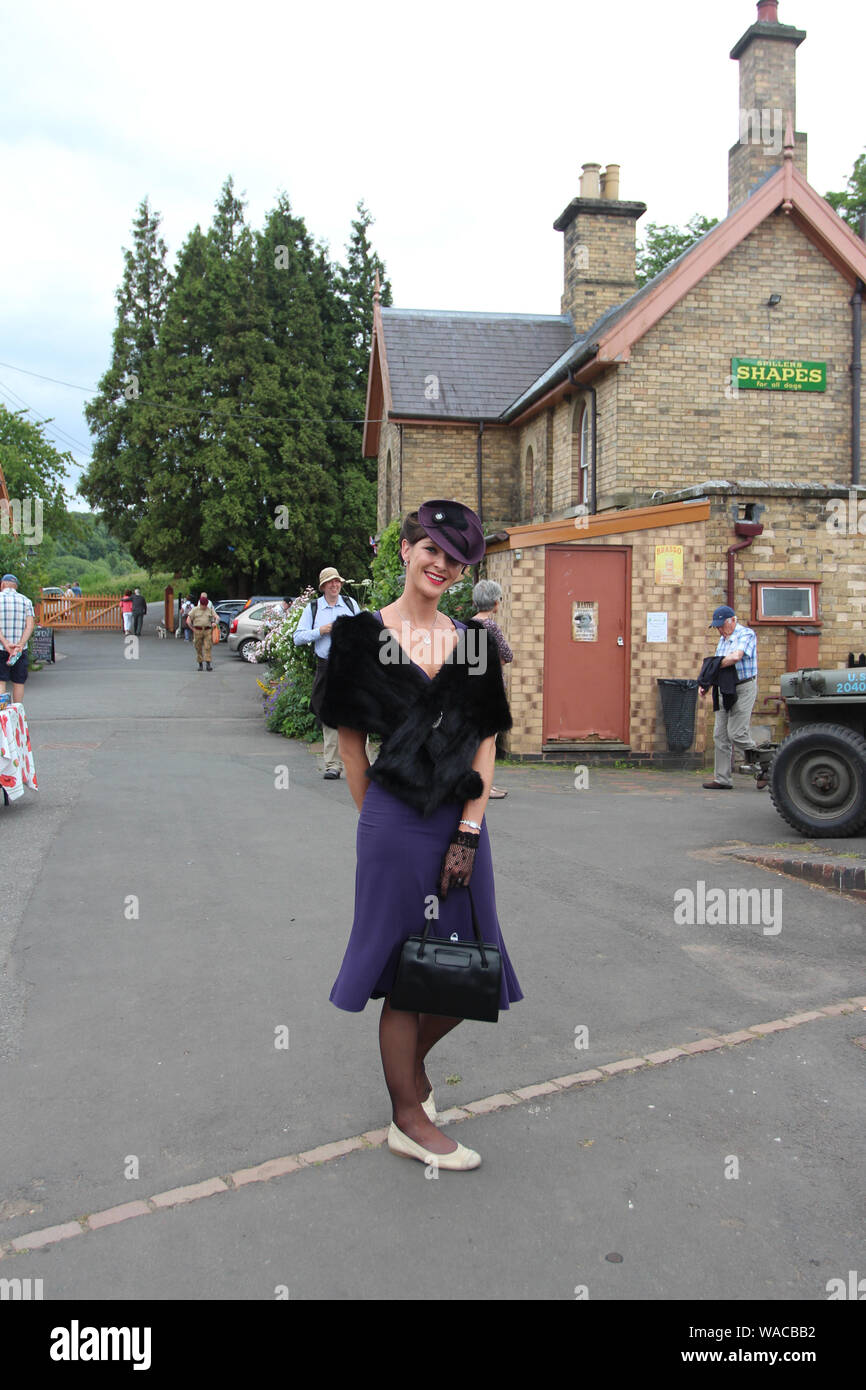 Arley, Bewdley, Worcestershire, United Kingdom, 6/27/2015, Severn Valley Railway Scenes, Beautiful Lady dressed in 40s Costume. in the settings of Old Stock Photo