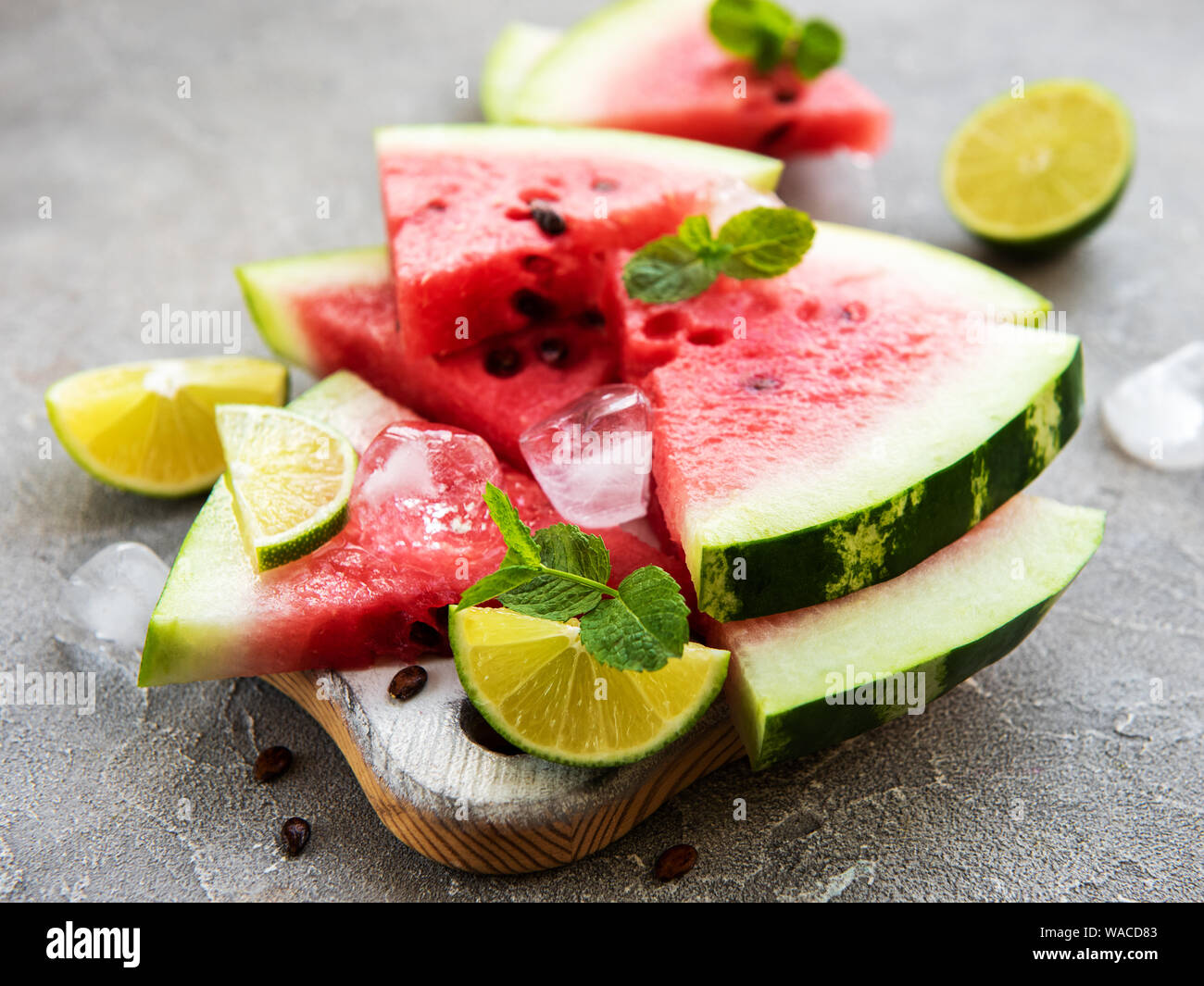 Watermelon with ice on a concrete background Stock Photo - Alamy