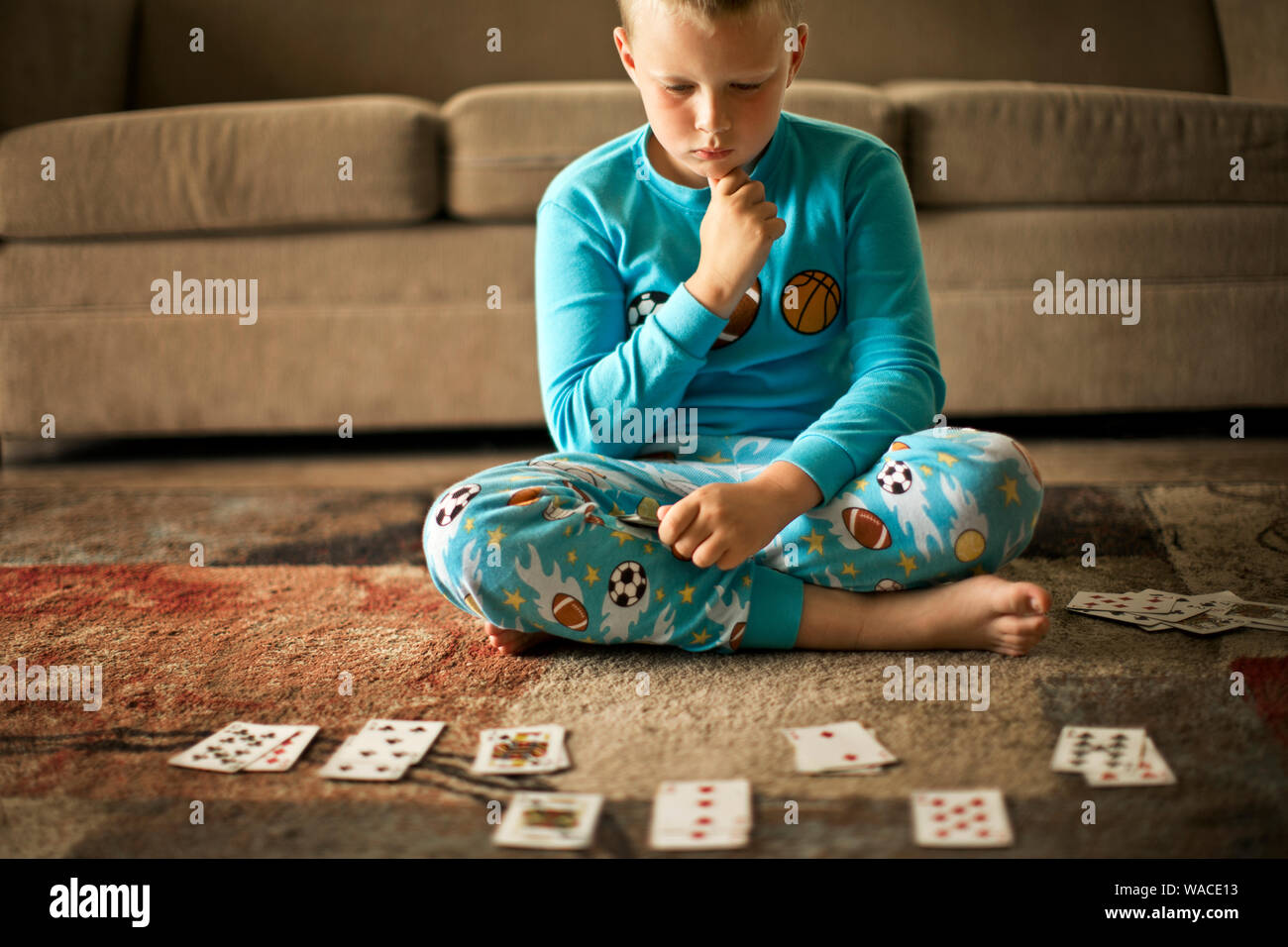 Young boy playing a card game. Stock Photo