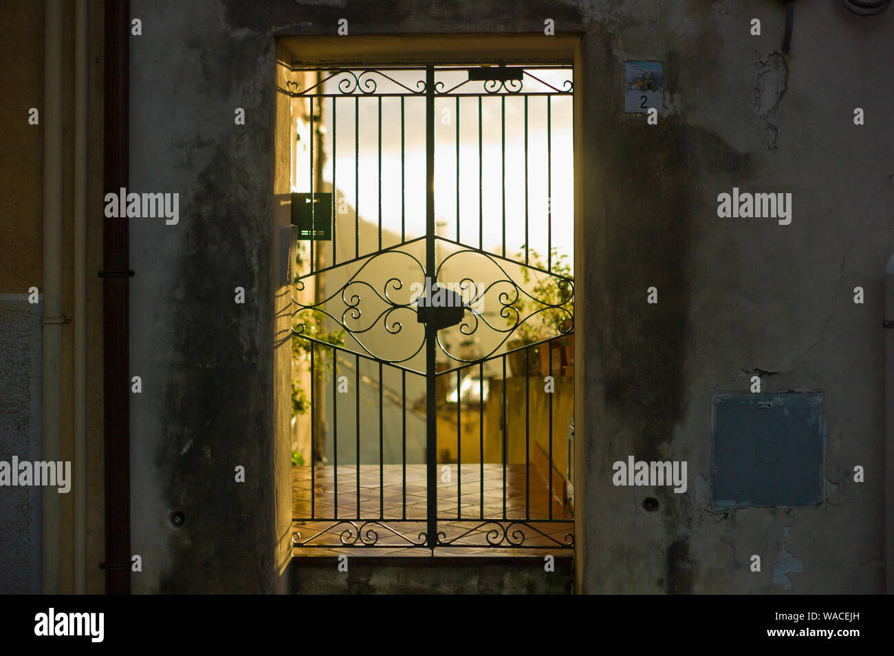 Closed iron gate at sunset Stock Photo Alamy