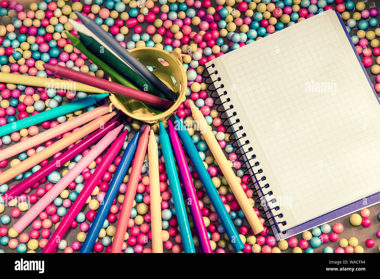 blank notebook and colored pencils on small colored balls Stock Photo