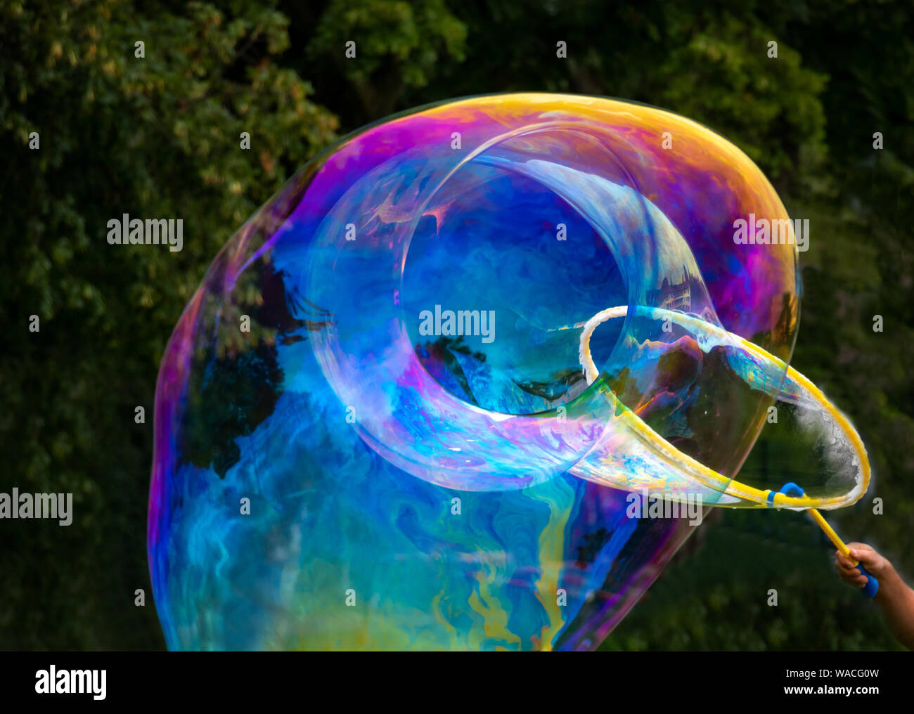 giant soapbubbles rainbow color, birthday party fun Stock Photo