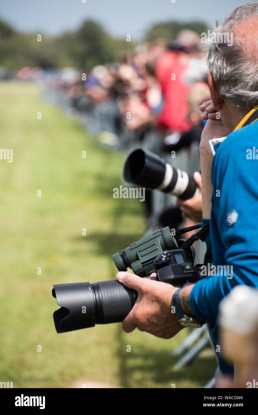 Cameras and binoculars at the edge of fence at an event (EDITORIAL USE ONLY) Stock Photo