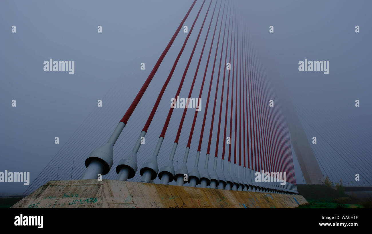 In this photo you can a metal bridge on a day with very thick fog. This photo was taken in December 2018 in Talavera de la Reina. Stock Photo