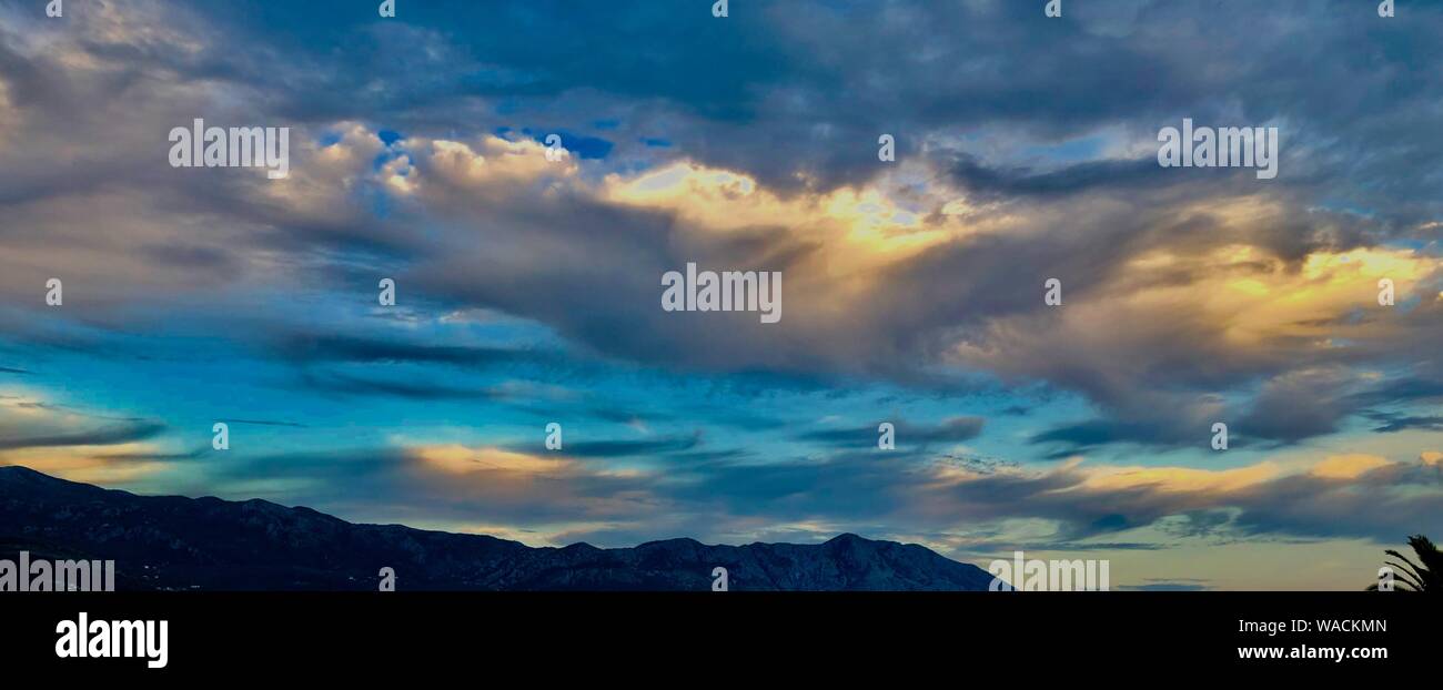 cloudy twilight sky in the mountains Stock Photo