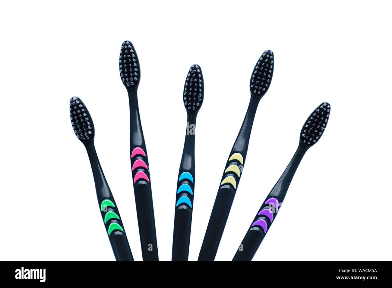 Five black toothbrushes with carbon soft bristles closeup. White