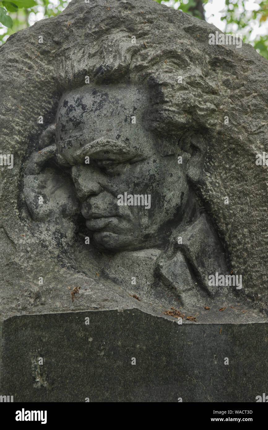 Grave of prominent Soviet writer Iosif Likstanov (1900 - 1955) at Ivanovskoye Cemetery in Yekaterinburg, Russia. The tombstone was designed by Russian sculptor Ernst Neizvestny (1956). The black granite headstone was first in a series of memorial headstones that Neizvestny executed in the Soviet Union. Stock Photo