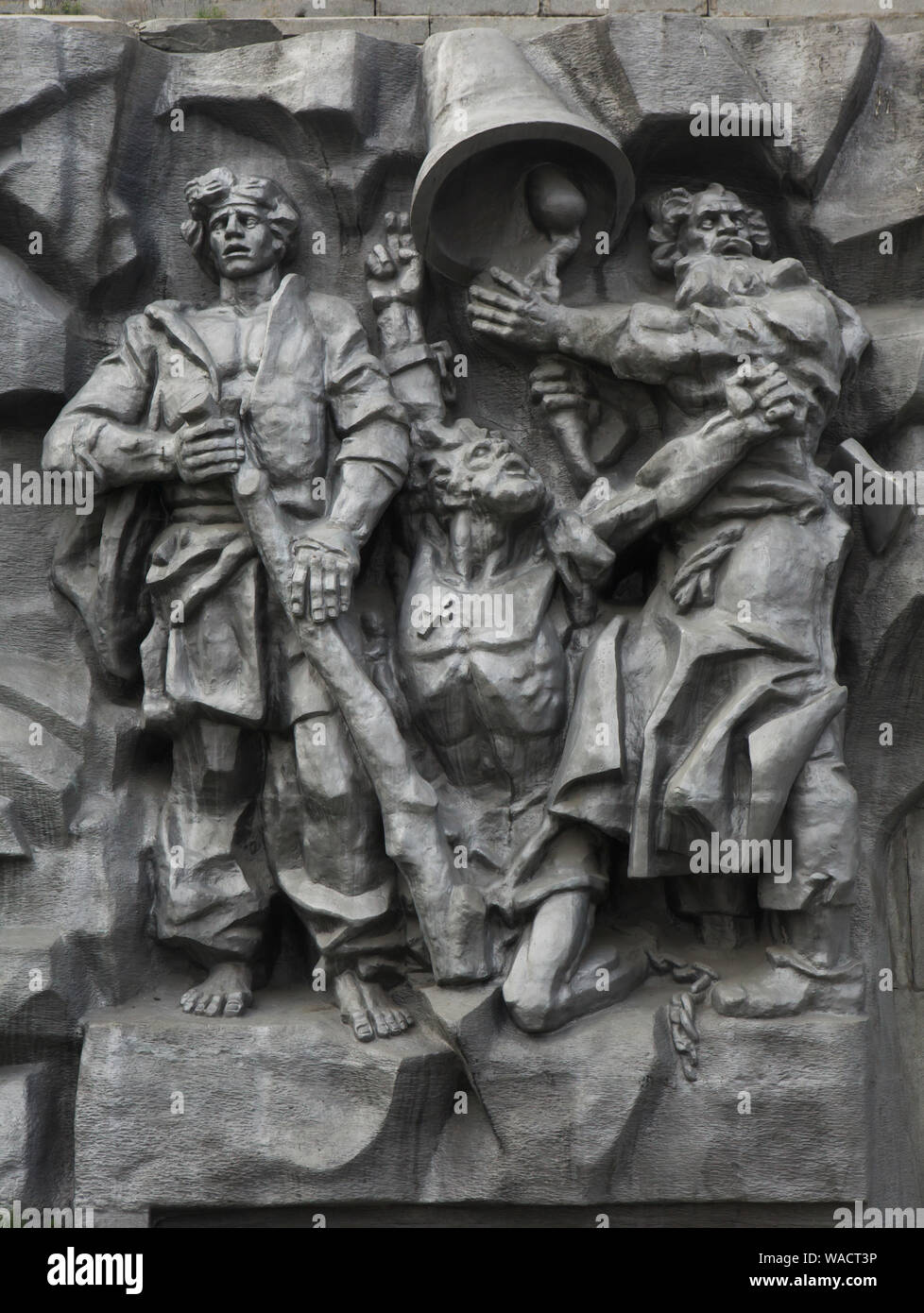 Raskolniki (Old Believers) who worked at the Yekaterinburg iron-making plant depicted in the large scale metal relief entitled 'The Birth of the City' in Yekaterinburg, Russia. The concrete high relief devoted to the history of the city was designed by Russian sculptor Pyotr Sharlaimov and unveiled in 1923 for the first time on the dam of the City Pond (Plotinka). In 1960, the relief was removed and destroyed. It was reconstructed and unveiled again in the 1980s. In 2017, the concrete relief was replaced by the metal one. Stock Photo