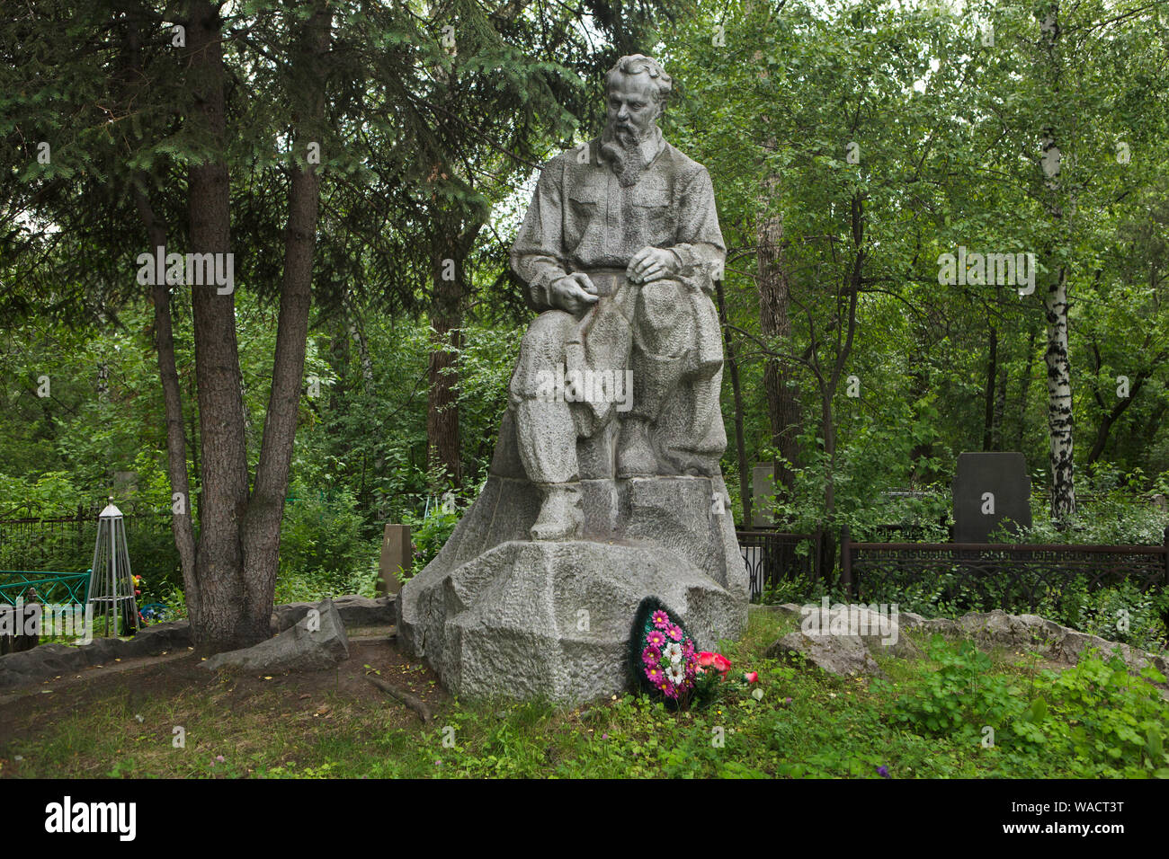 Grave of Russian writer Pavel Bazhov at Ivanovskoye Cemetery in Yekaterinburg, Russia. The statue on the grave was designed by Soviet sculptor Vladimir Yegorov. Stock Photo