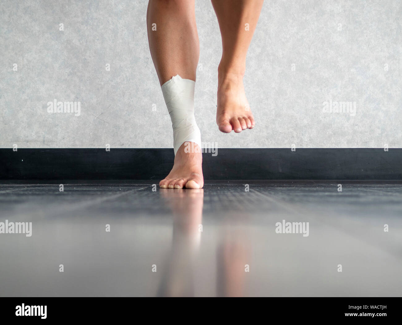 Athlete balancing to regain proprioception on sprained ankle Stock