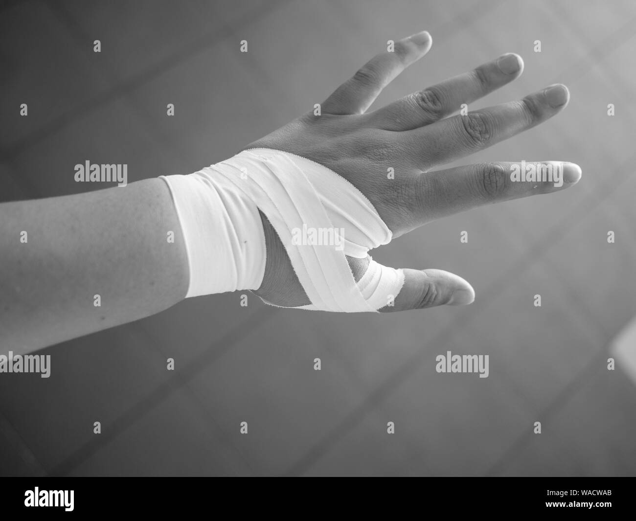 Black and white version of Athlete with a taped thumb Stock Photo