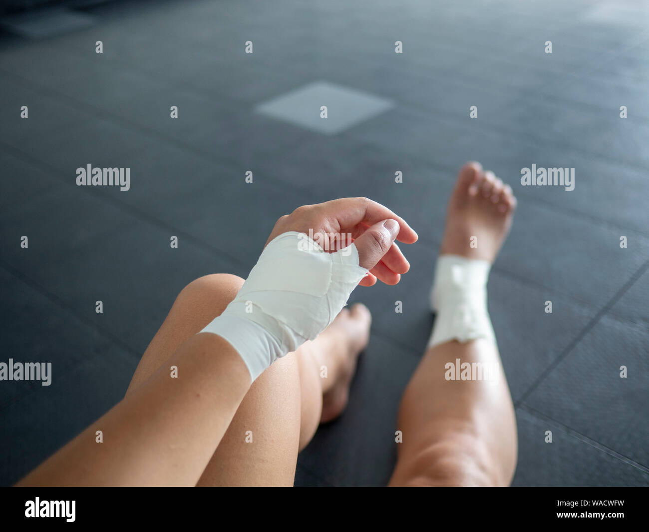 The injured athlete athlete with thumb and ankle injuries and tape