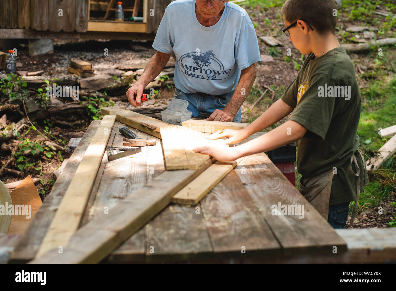 Two people work together to build a storage shed in do-it-yourself project at home. Stock Photo