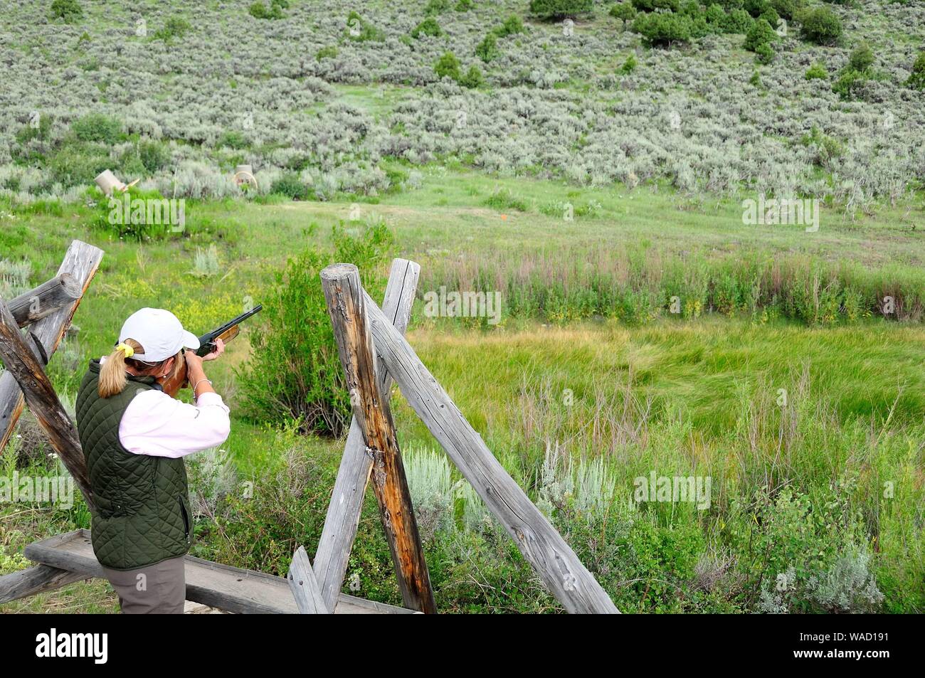 Cathy Beck shooting clay birds while visiting Colorado Stock Photo