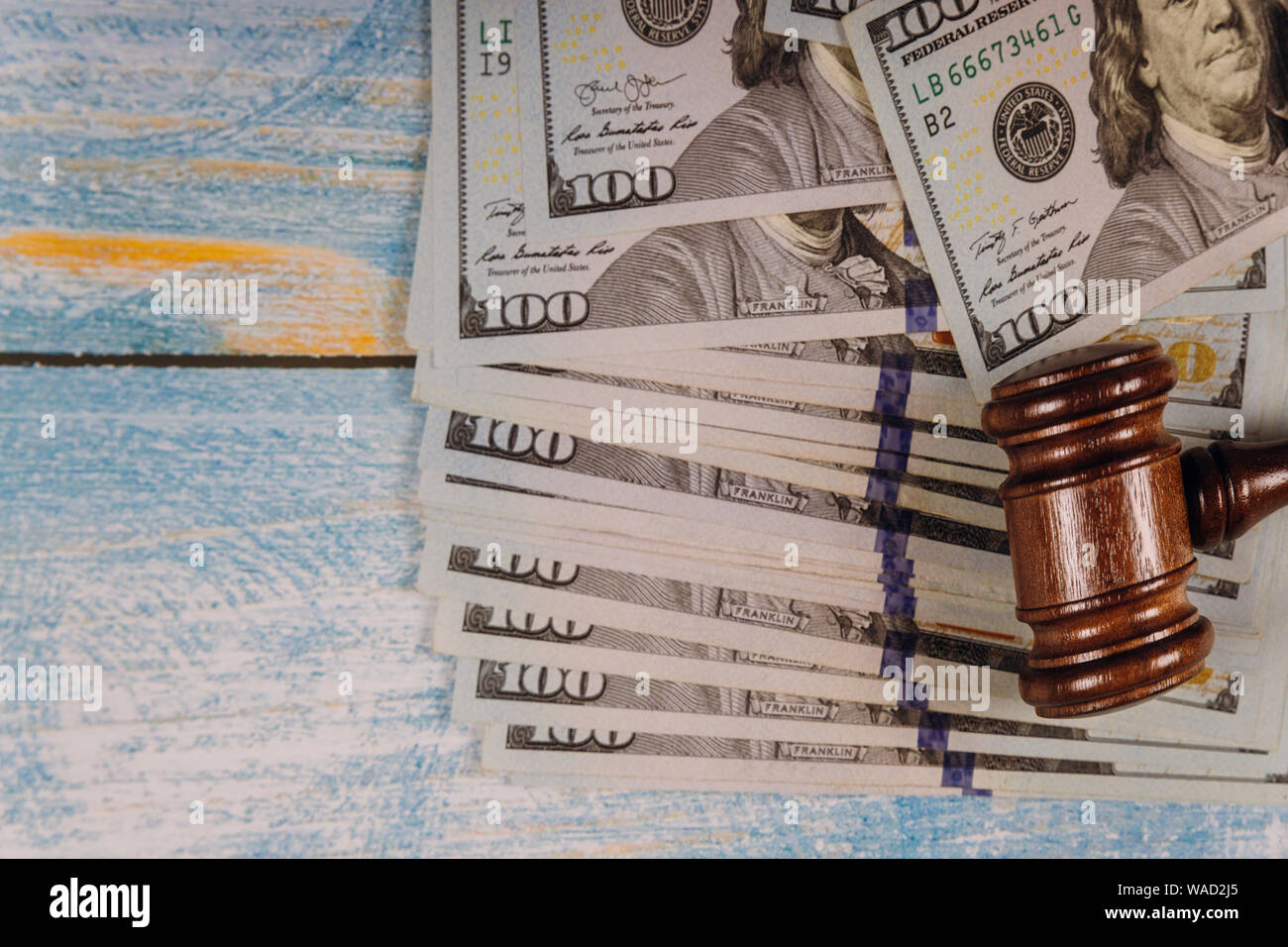 Judges court gavel and money on blue table. Stock Photo