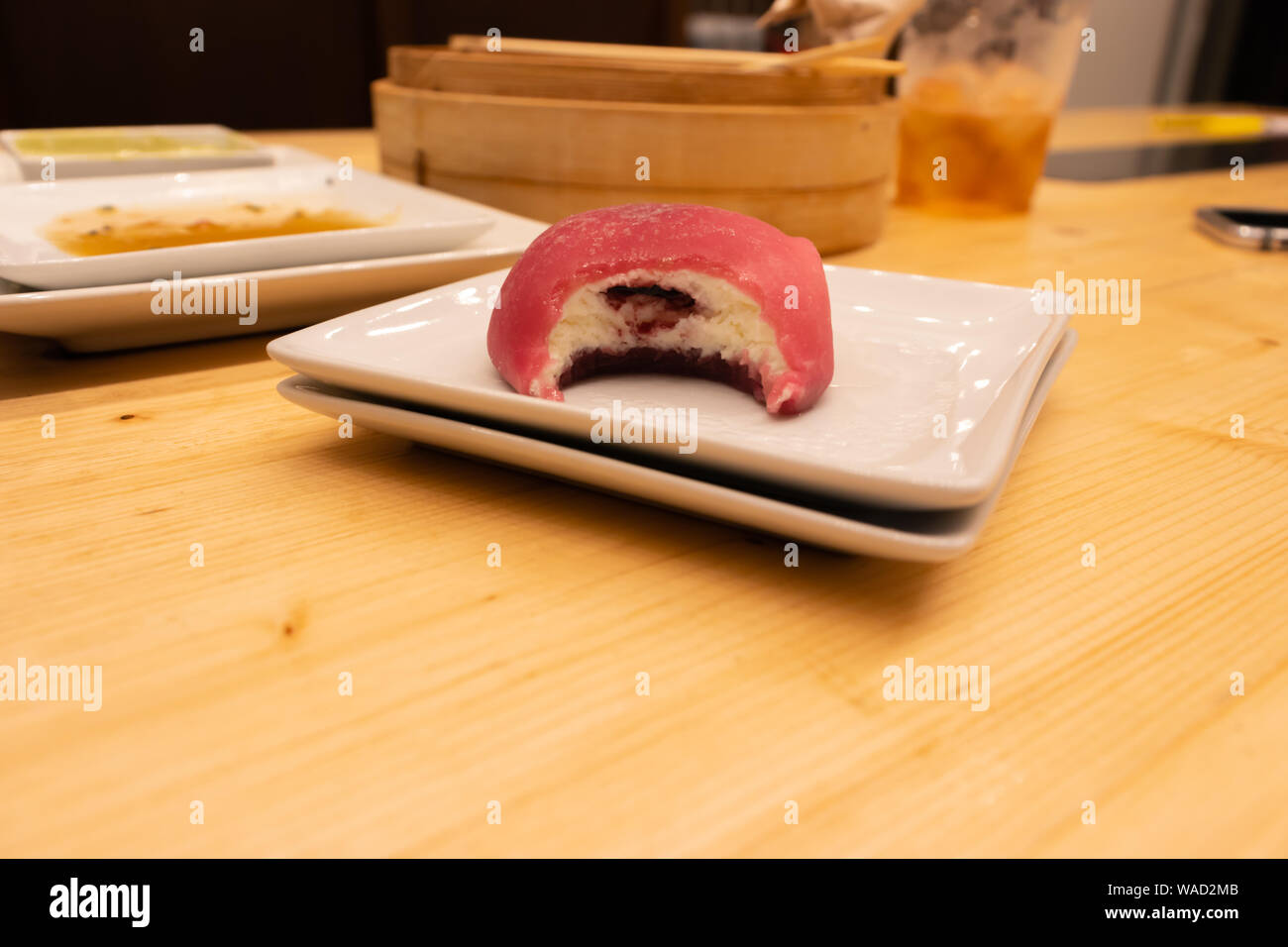 Red Raspberry Big Mochi On A Plate On A Wooden Table In An Asian Restaurant Or Chinese Dumplings 