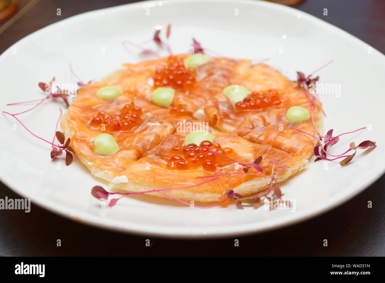 Salmon fillet and roe on Indian roti cake, fusion style dish Stock Photo