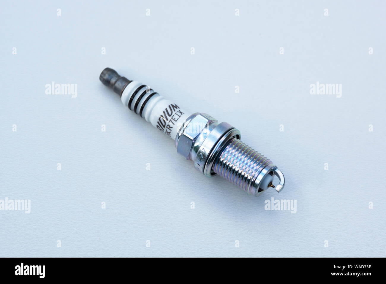 A single new spark plug for a modern petrol combustion engine Stock Photo