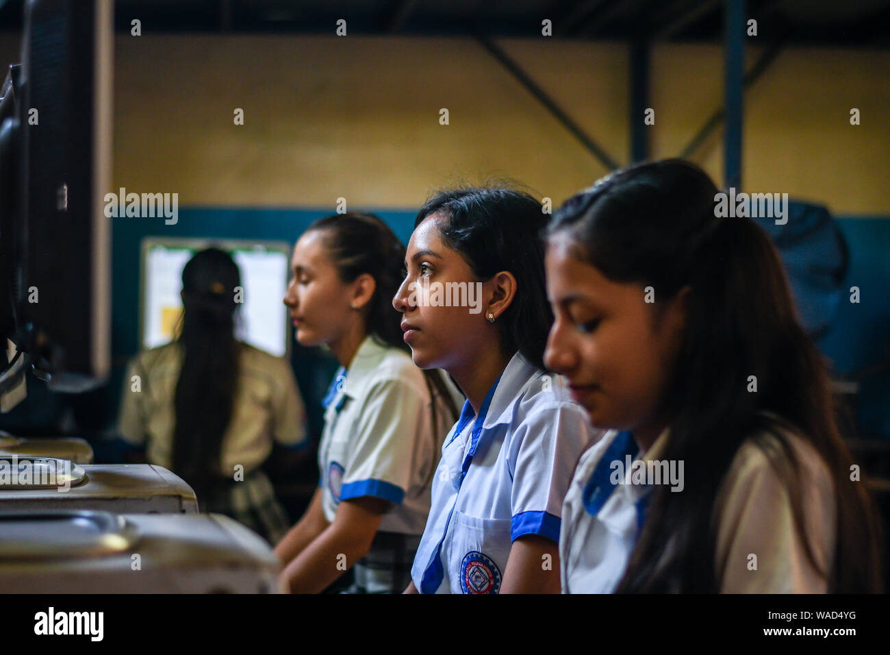 latin female students working on computers at college in Guatemala Stock Photo