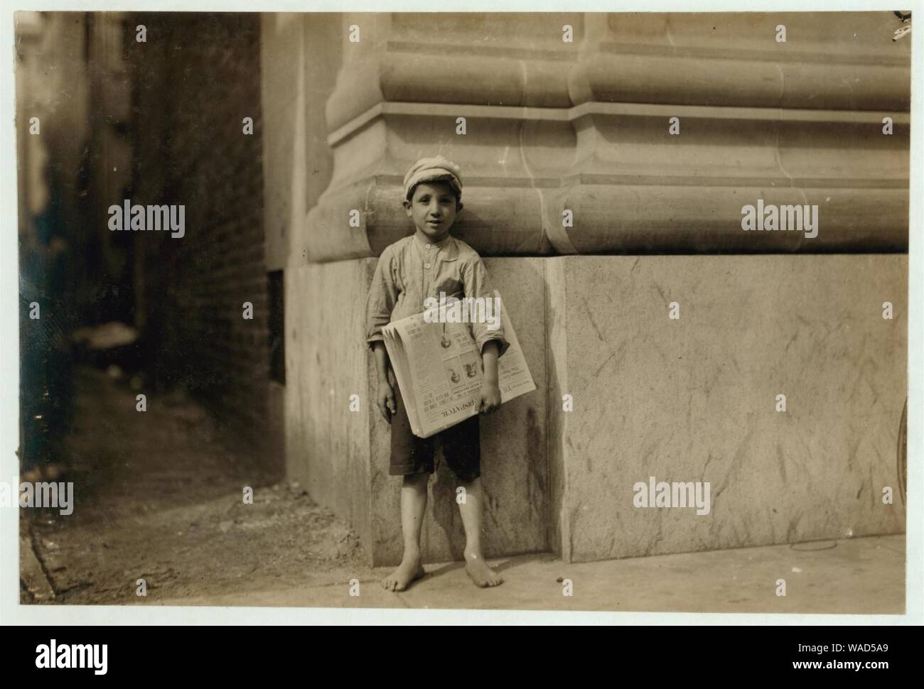 Dominick, a young Norfolk newsboy. There are too many youngsters selling papers in the Virginia Cities. Stock Photo