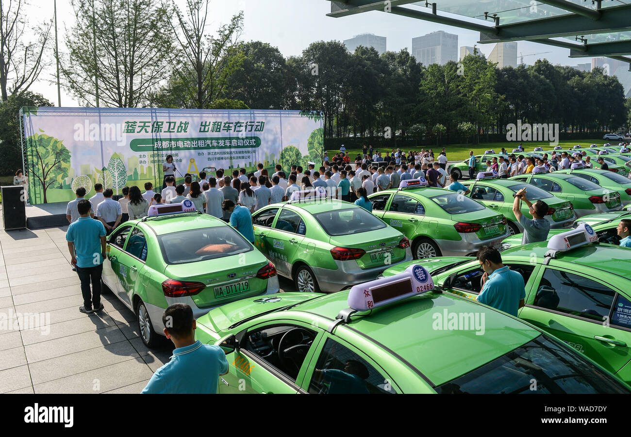 Rows of electric taxis to reduce car emissions and improve the air quality are parked during a launch event in Chengdu city, southwest China's Sichuan Stock Photo