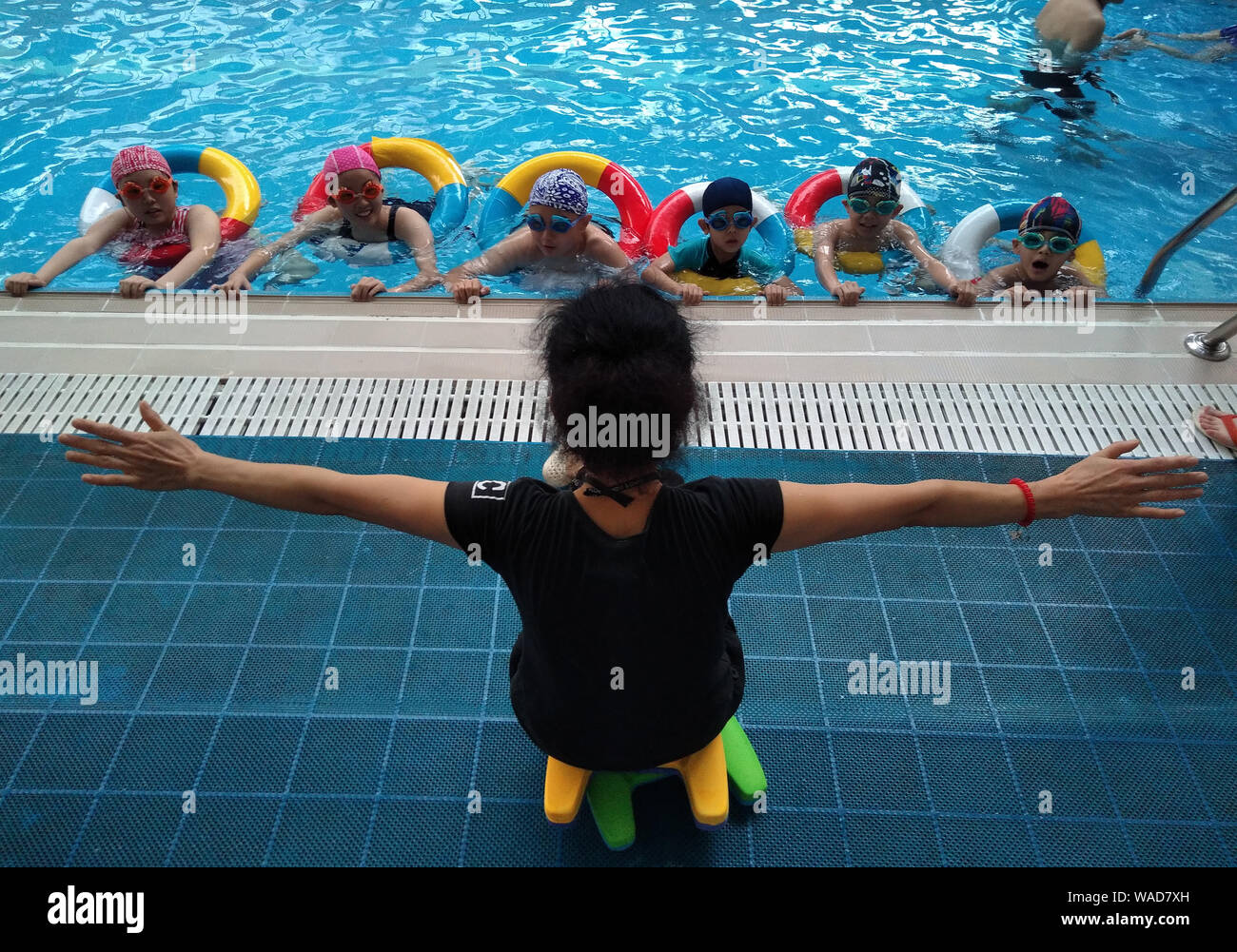 A Chinese coach instructs young kids to learn swimming in the pool at a  swimming hall on a scorching day during the summer vacation in Zhengzhou  city Stock Photo: 264593689 - Alamy