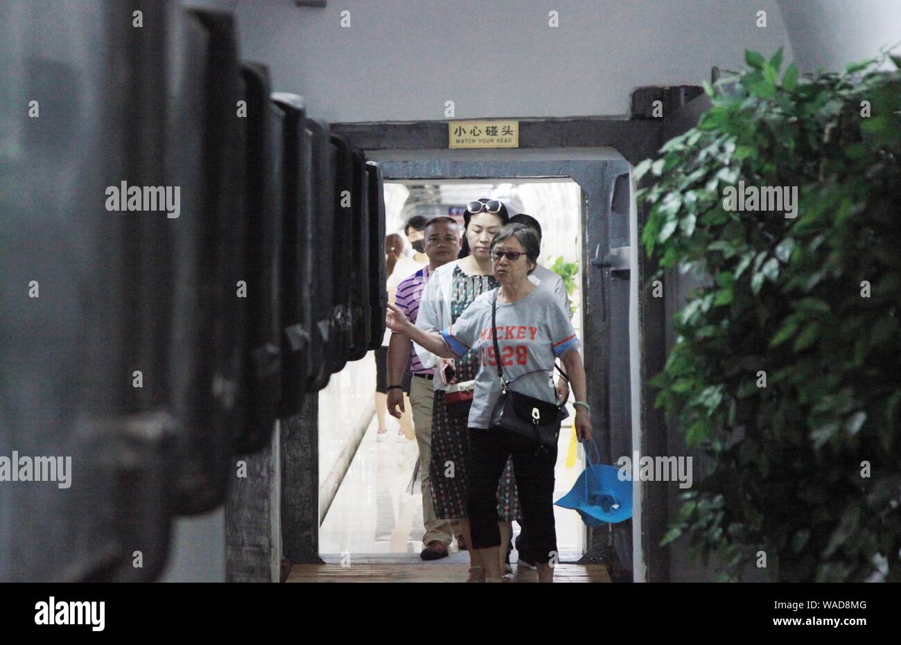 Local residents rest in a bomb shelter against scorching days in
