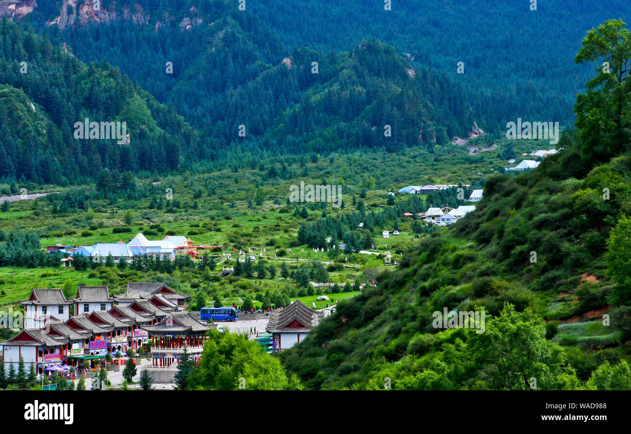 View from adjacent hill of villages scattering among Qilian Mountains and forest, Sunan Yugur Autonomous County, Zhangye city, northwest China's Gansu Stock Photo
