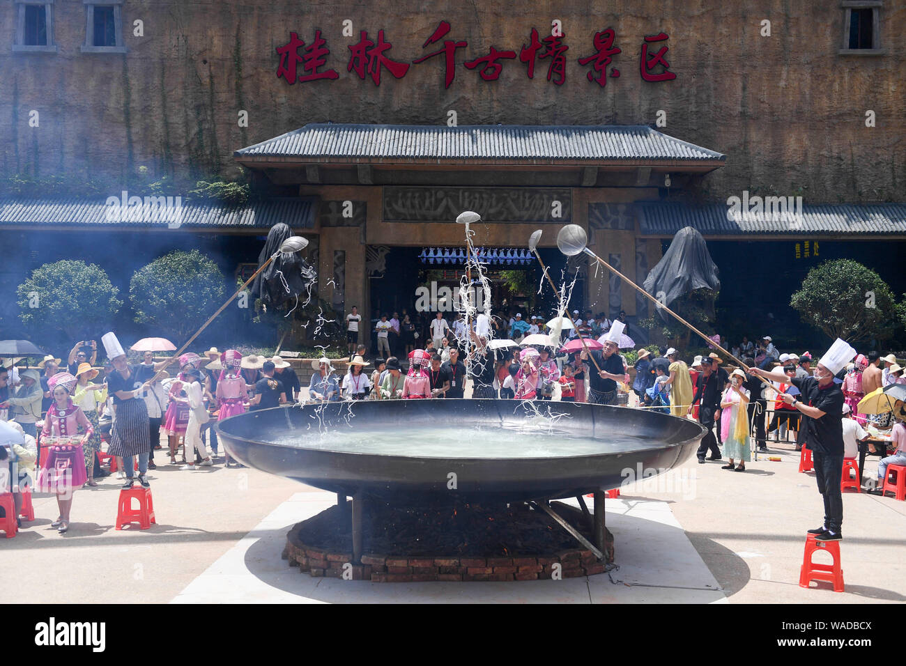 Chefs get the rice noodle delivered by a Chinese entertainer dressed in